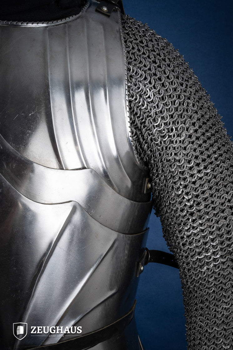 A polished Gothic cuirass featuring a breastplate and back plate, showcasing intricate designs and flexible construction.