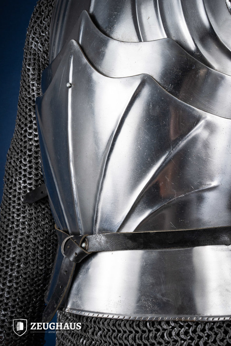 A polished Gothic cuirass featuring a breastplate and back plate, showcasing intricate designs and flexible construction.