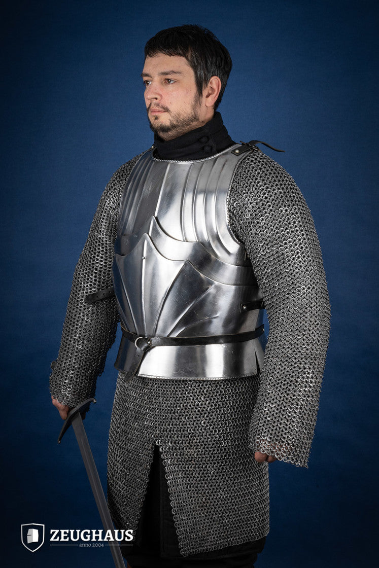 A polished Gothic cuirass featuring a breastplate and back plate, showcasing intricate designs and flexible construction.