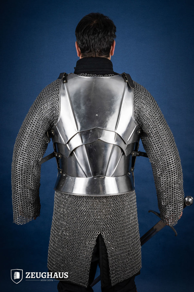 A polished Gothic cuirass featuring a breastplate and back plate, showcasing intricate designs and flexible construction.