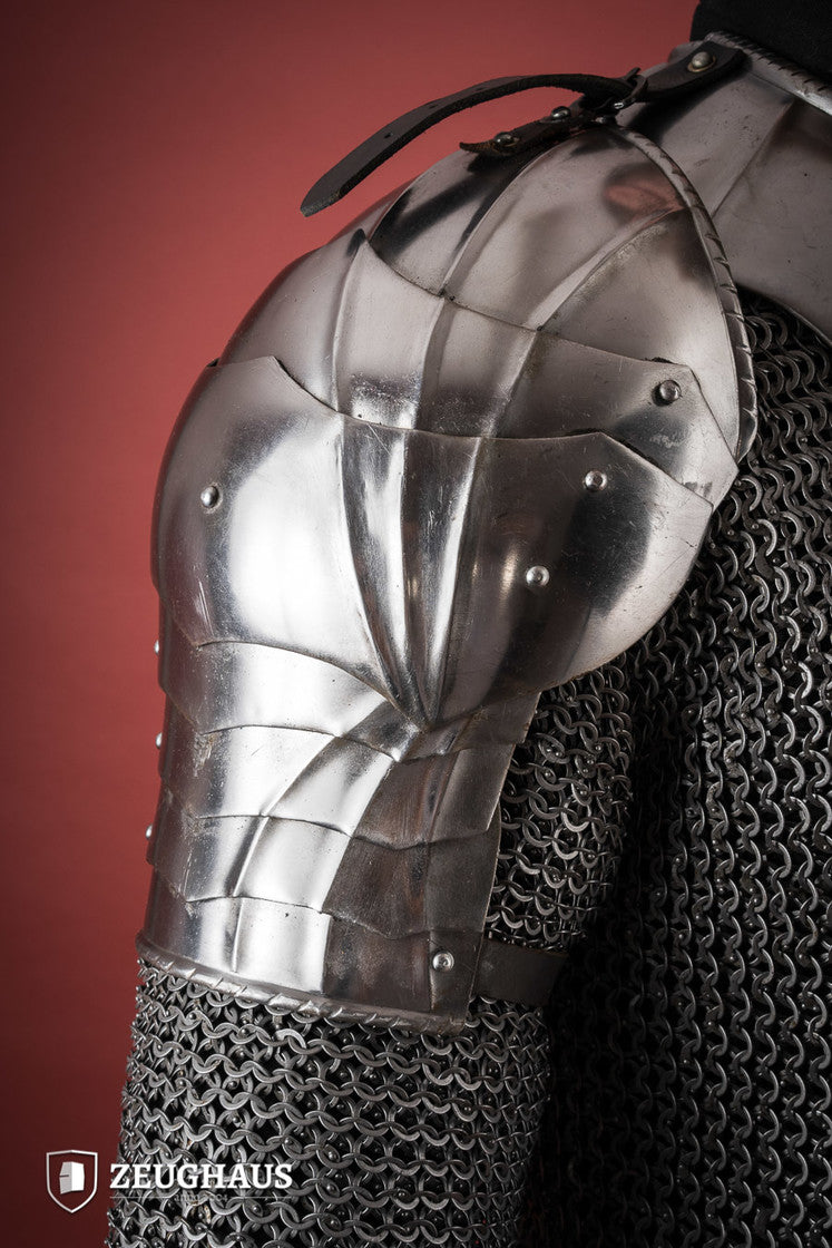 Polished Gothic Pauldrons with fluted design, showcasing flexibility and craftsmanship, ideal for medieval reenactments.