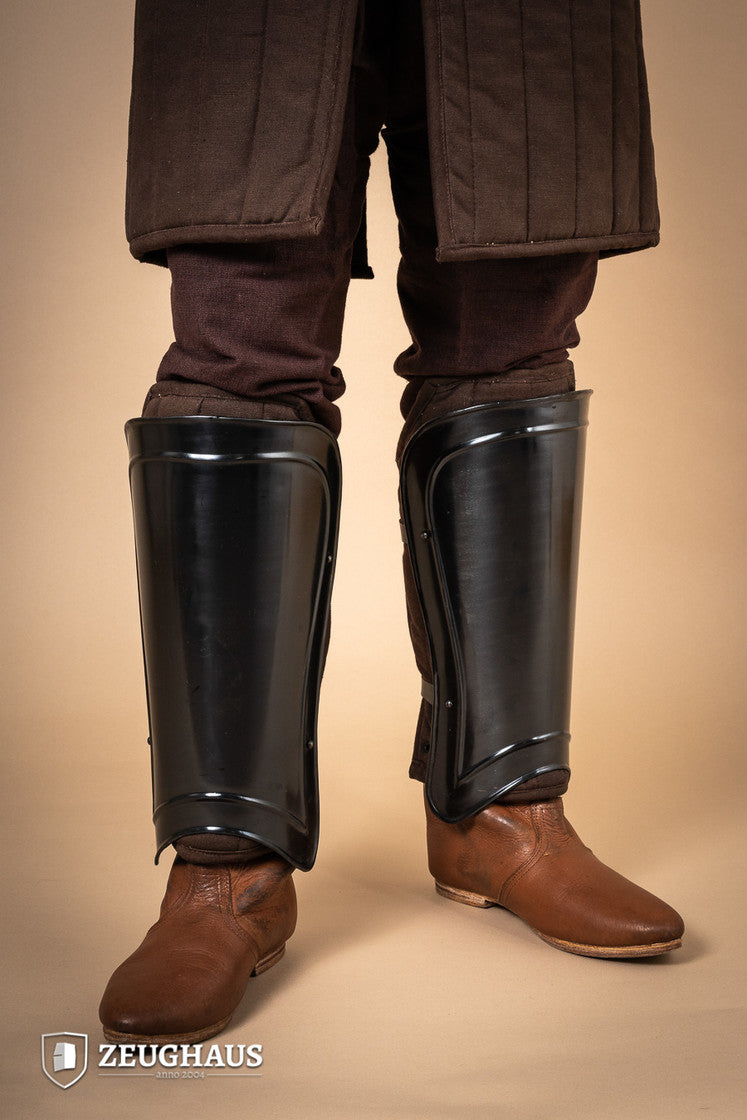 Greaves Warrior Burnished, protective leg armor with a snug fit and leather straps, designed for comfort and durability.