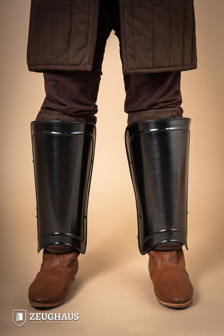 Greaves Warrior Burnished, protective leg armor with a snug fit and leather straps, designed for comfort and durability.