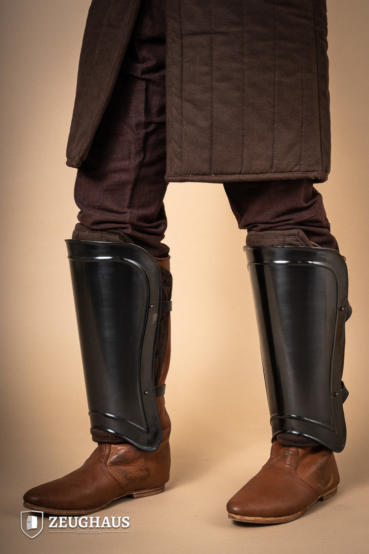 Greaves Warrior Burnished, protective leg armor with a snug fit and leather straps, designed for comfort and durability.