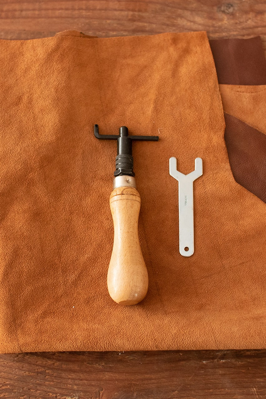Hand Groover featuring an iron blade and a wooden handle, designed for precise sink-stitching in leatherworking.