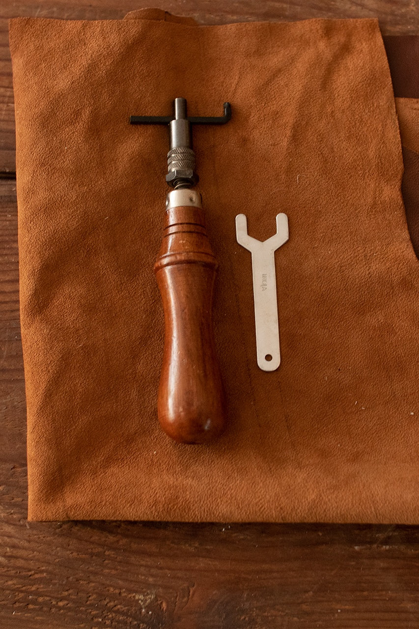 Hand Groover featuring a durable iron tip and a comfortable wooden handle, designed for precise sink-stitching.