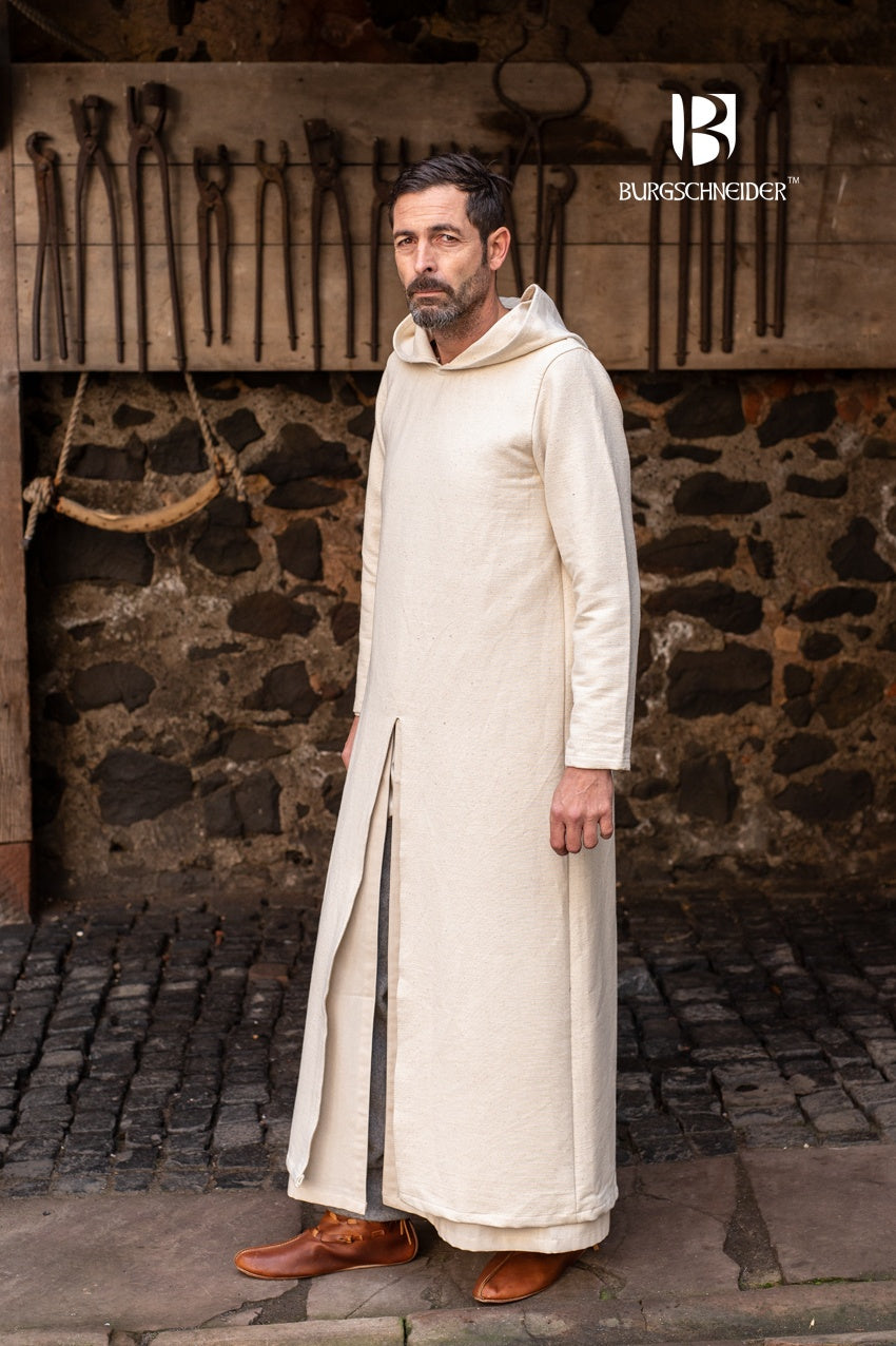 A long-sleeved hooded tunic in natural color, draping elegantly to the feet with front and back slits for movement.