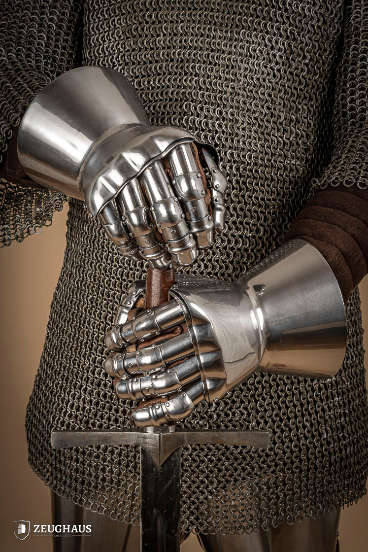 A pair of Hourglass Gauntlets made from 1.6mm steel, featuring a dramatic cuff design and leather gloves for comfort.