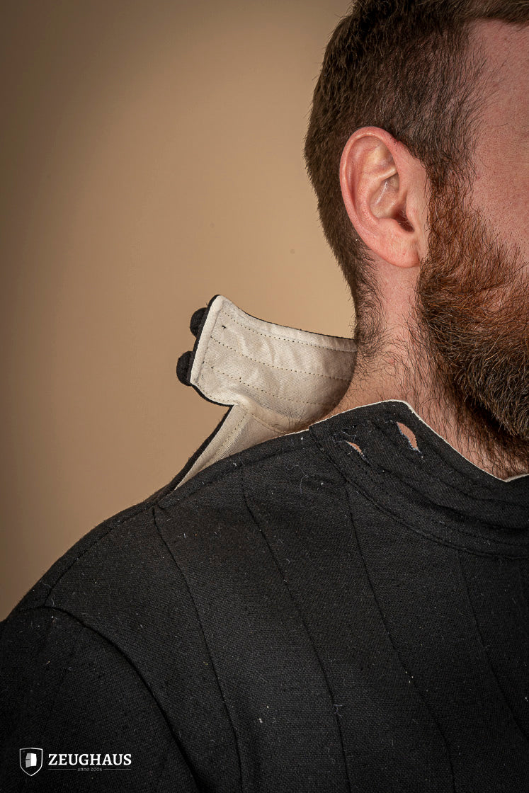 Infantry Gambeson Black featuring neck button closure and slits for mobility, made of 100% cotton with linen pattern.