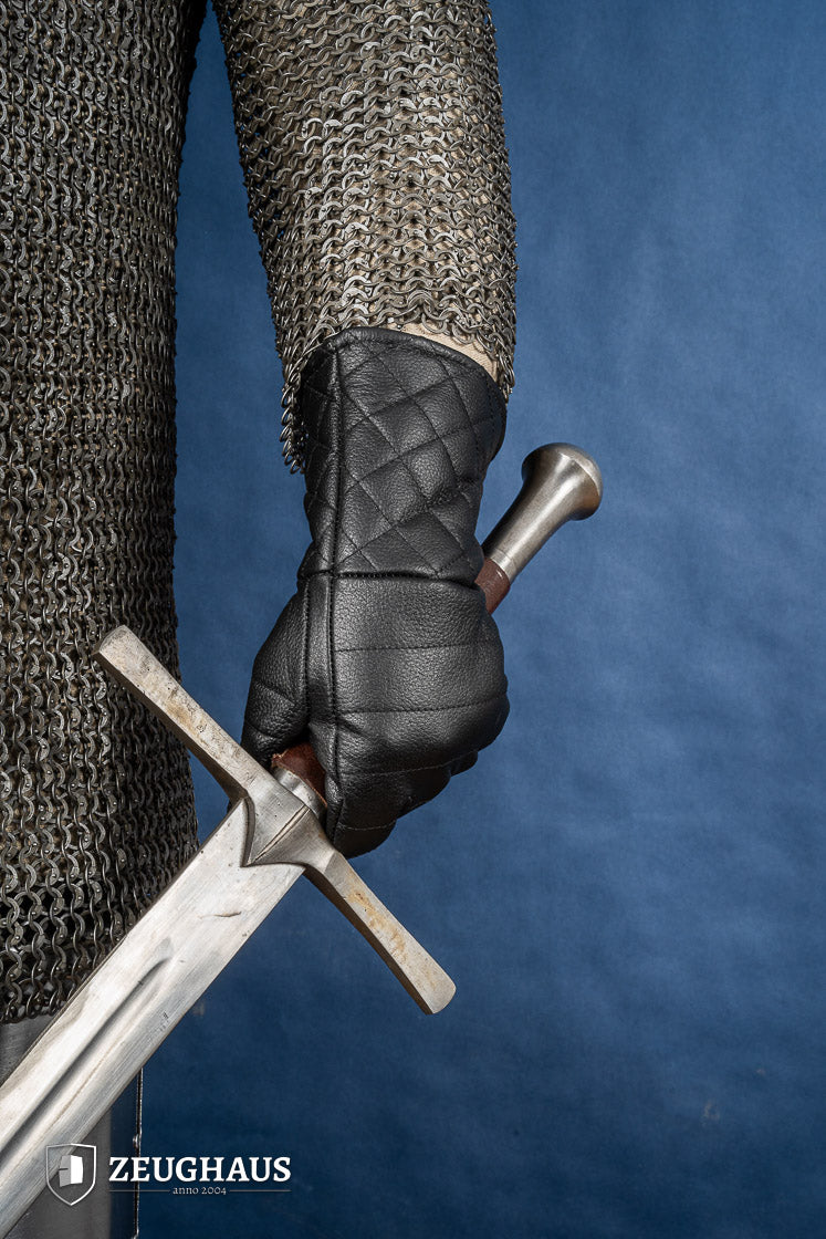 A pair of premium black leather gloves designed for martial arts, showcasing natural leather texture and craftsmanship.