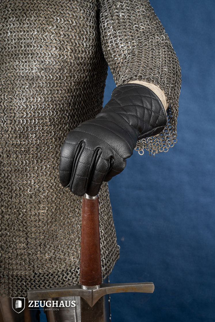 A pair of premium black leather gloves designed for martial arts, showcasing natural leather texture and craftsmanship.