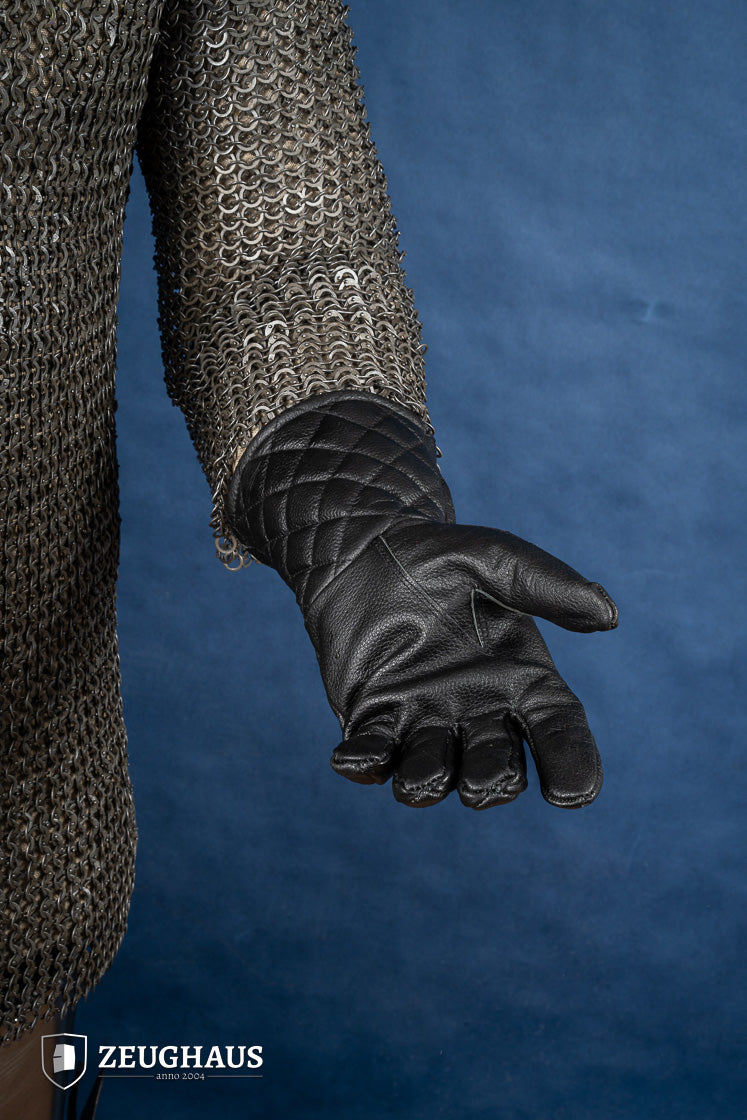 A pair of premium black leather gloves designed for martial arts, showcasing natural leather texture and craftsmanship.