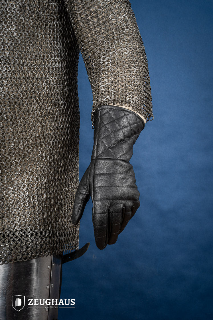 A pair of premium black leather gloves designed for martial arts, showcasing natural leather texture and craftsmanship.