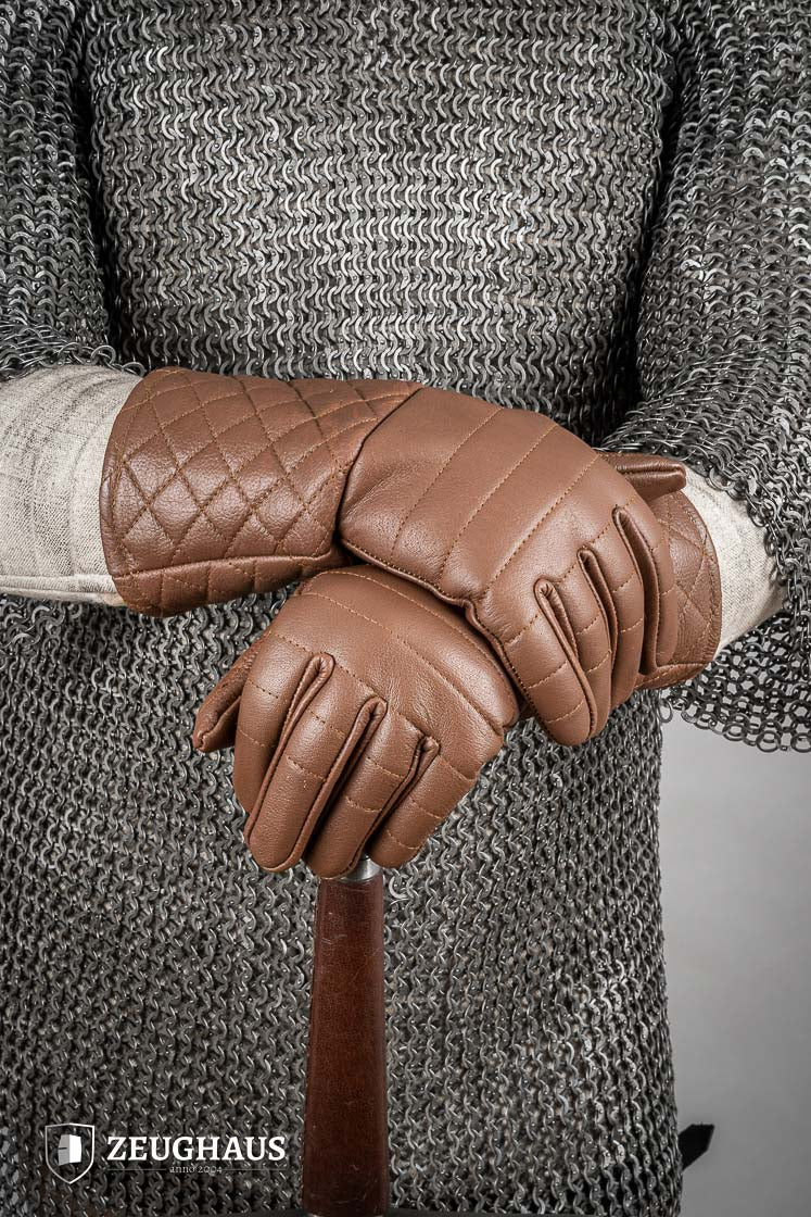 A pair of brown leather gloves designed for martial arts, showcasing natural imperfections and unique color variations.
