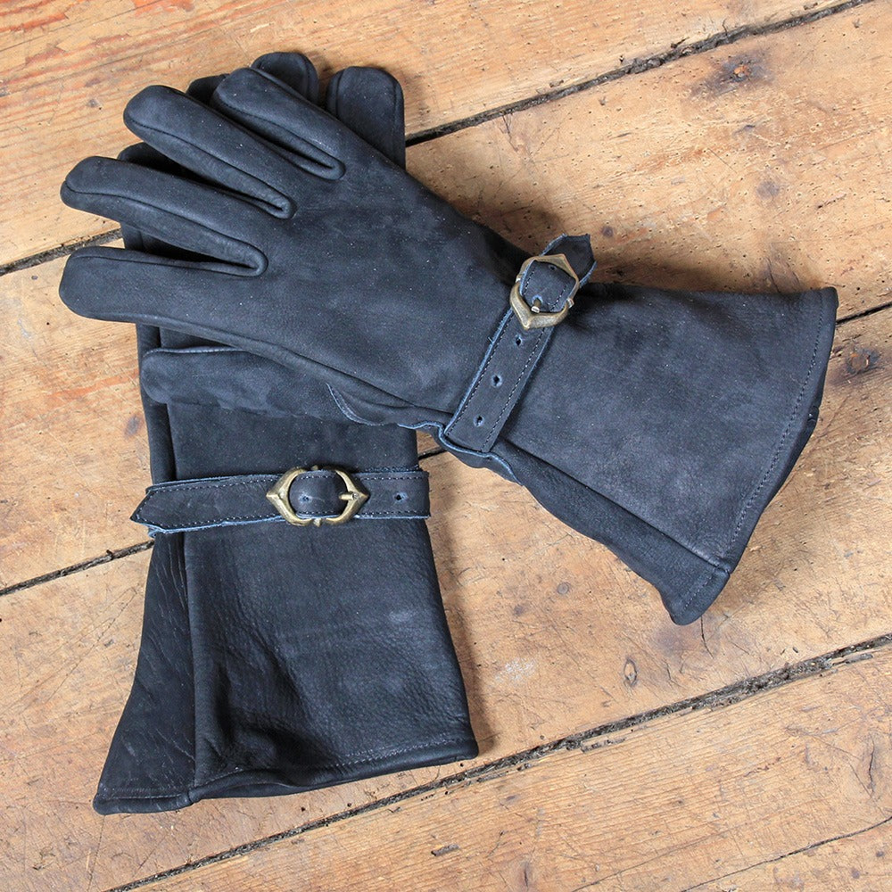 A pair of Ulex Black Leather Gloves made from soft cowhide leather, featuring a stylish brass buckle and a longer cuff for wrist protection.