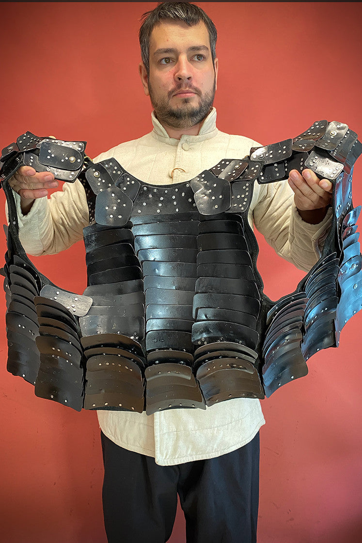 Leeds Brigantine Black armor made of steel and studded suede leather, featuring adjustable leather straps and multiple metal plates for protection and mobility.