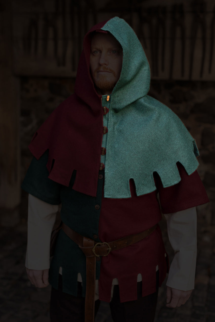 Left Side Cowl Dangereuse Green featuring a close-fitting hood, rustic wooden buttons, and crenelated pinnacles, made from sturdy wool fabric.