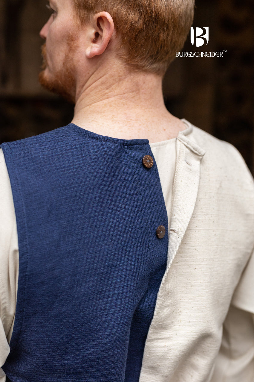 Left Side Tabard Auderic Blue featuring stylish wooden buttons and wide armholes, made from heavy cotton fabric.