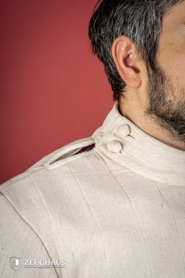 Light Gambeson with Mittens Natural featuring a high collar and sewn mittens, designed for warmth and protection.