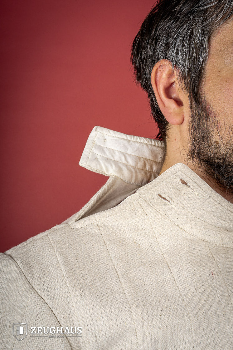 Light Gambeson with Mittens Natural featuring a high collar and sewn mittens, designed for warmth and protection.