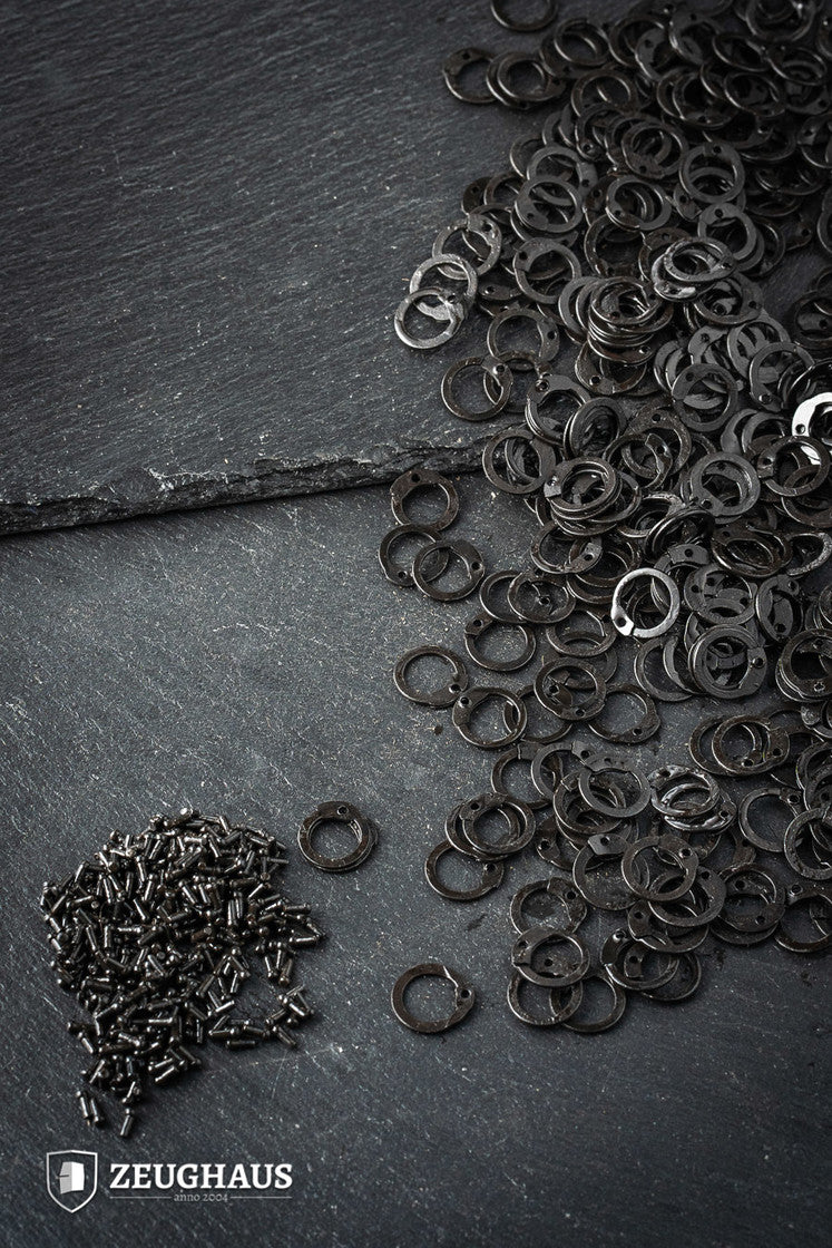 A collection of 9mm loose flat rings made of mild steel with a burnished finish, featuring rivets for added strength.