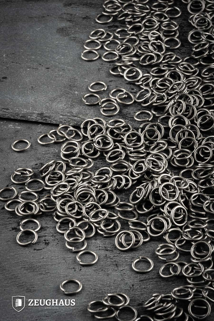 A collection of loose round rings made from mild steel, featuring a natural oiled finish, with an inner diameter of 9mm.