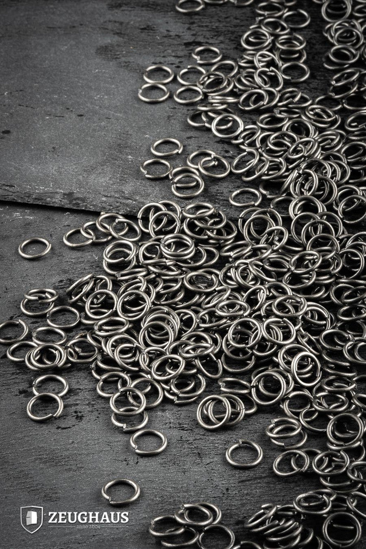 A collection of loose round rings made from mild steel, featuring a natural oiled finish, with an inner diameter of 9mm.