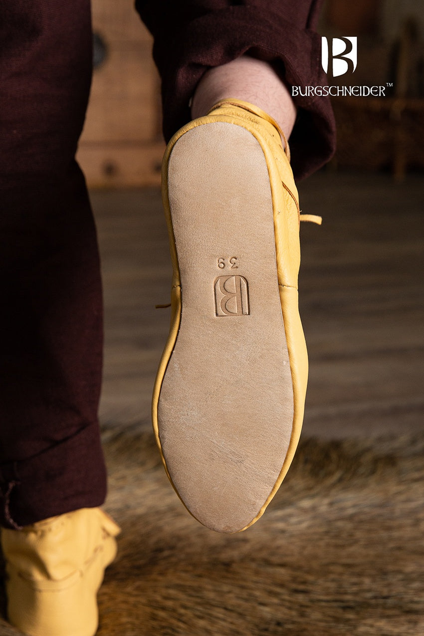 Light brown medieval shoes with lacing, showcasing a classic design suitable for reenactments and fairs.