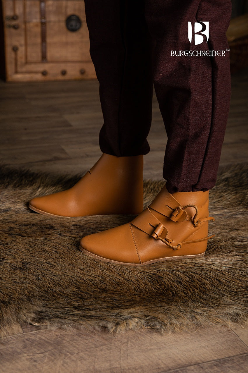 A pair of dark brown Jorvik Medieval Shoes made from leather, featuring two flaps for closure, showcasing their authentic medieval design.