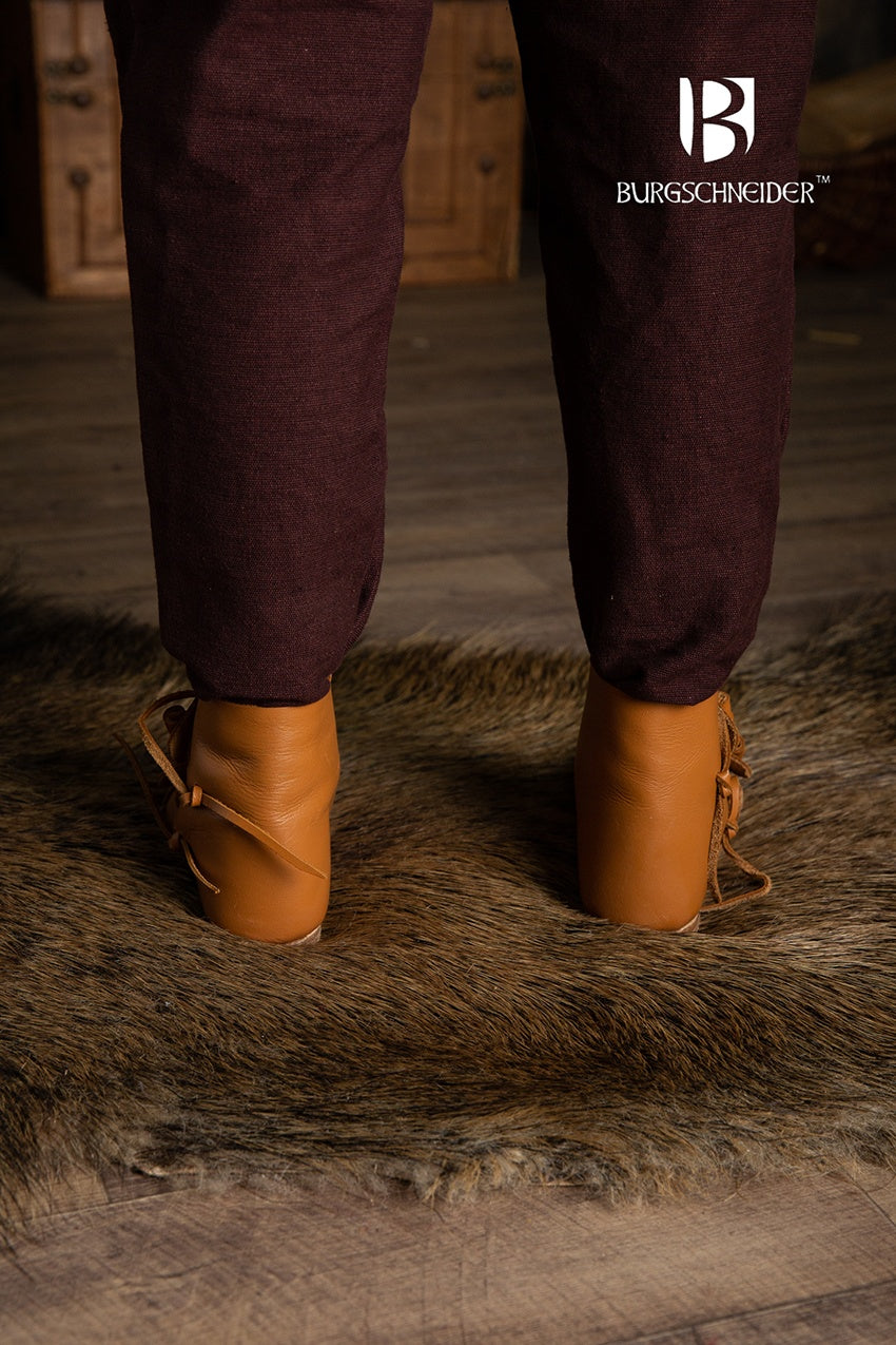 A pair of dark brown Jorvik Medieval Shoes made from leather, featuring two flaps for closure, showcasing their authentic medieval design.