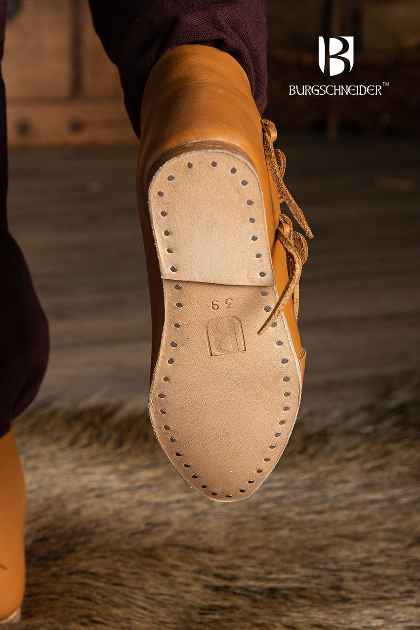 A pair of dark brown Jorvik Medieval Shoes made from leather, featuring two flaps for closure, showcasing their authentic medieval design.
