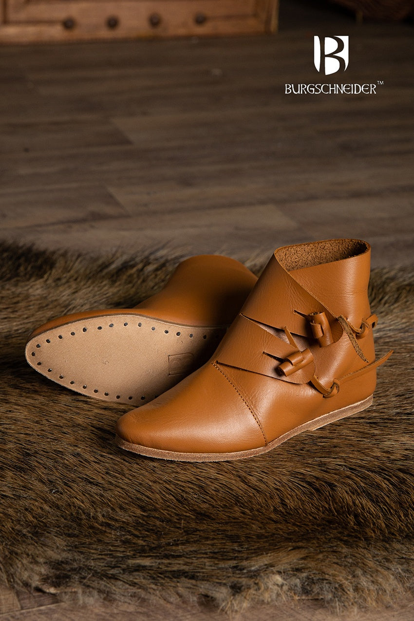 A pair of dark brown Jorvik Medieval Shoes made from leather, featuring two flaps for closure, showcasing their authentic medieval design.