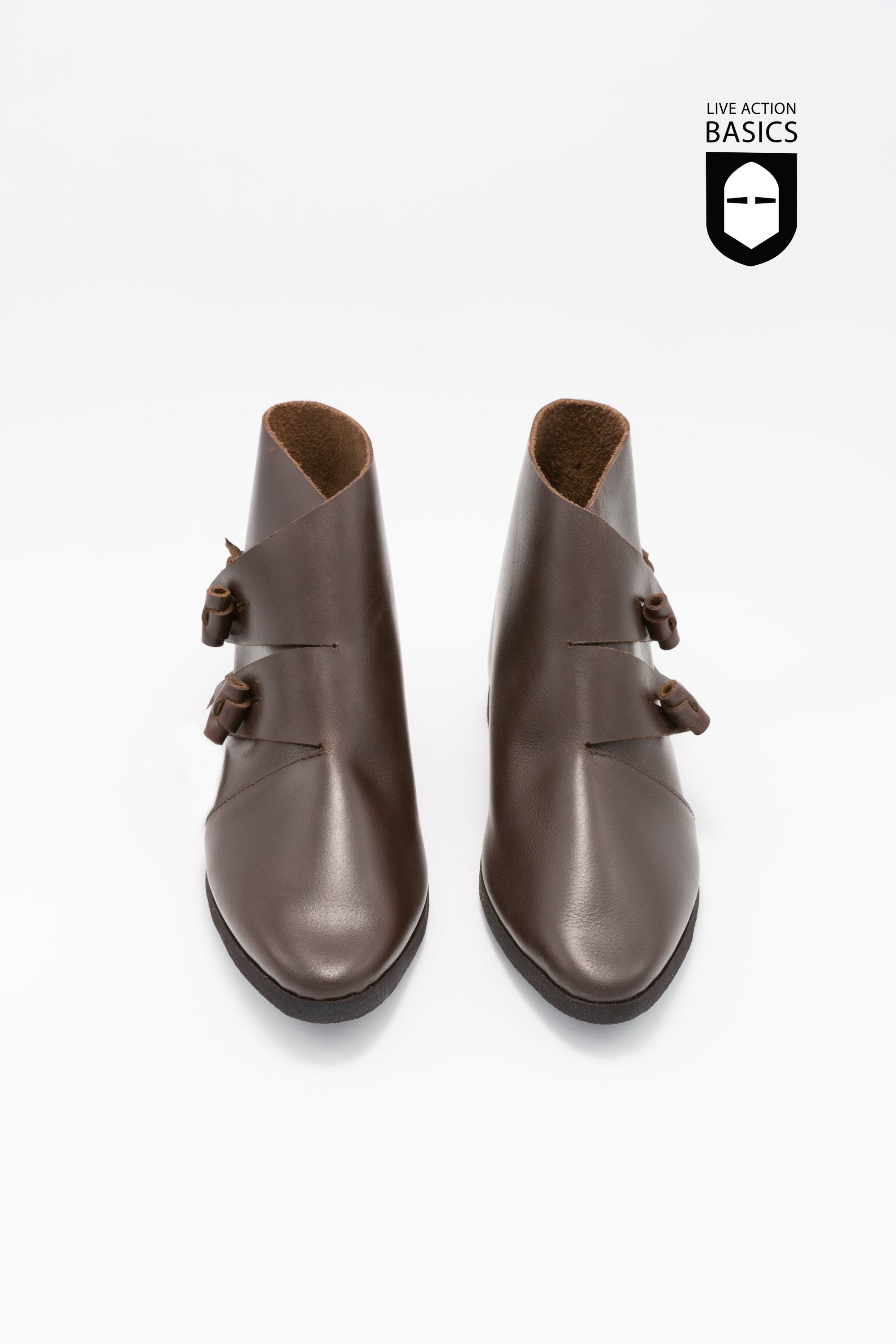 A pair of dark brown medieval shoes made from high-quality leather, featuring a cleated sole and leather strip fastening.