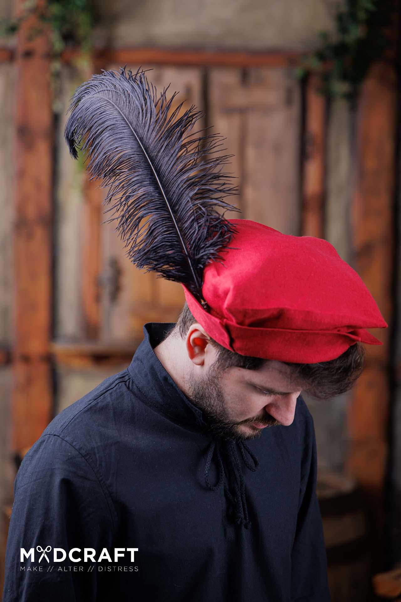 A striking black ostrich feather measuring 45-50cm, perfect for enhancing medieval hats and costumes.