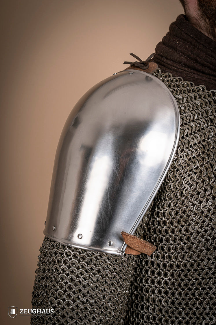 Polished steel pauldrons from 1350-1425, showcasing intricate craftsmanship and historical design.