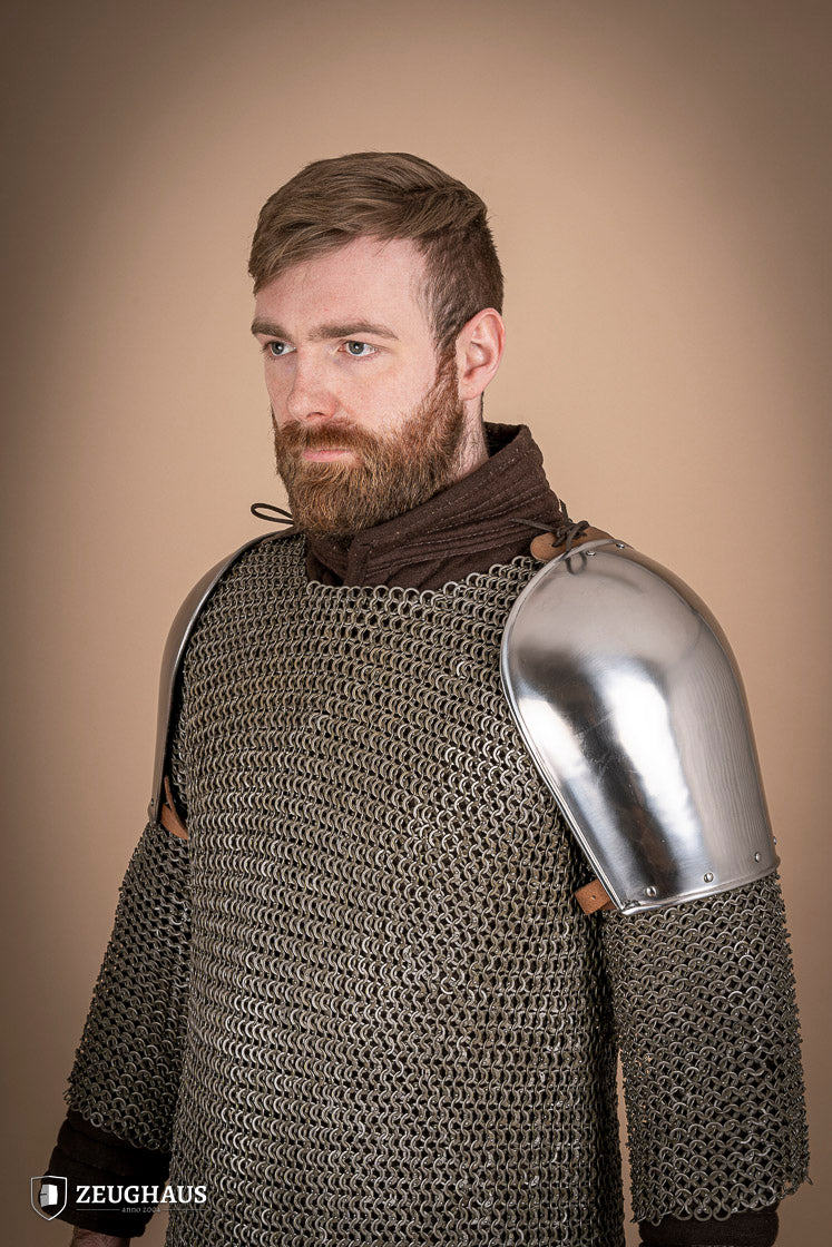 Polished steel pauldrons from 1350-1425, showcasing intricate craftsmanship and historical design.