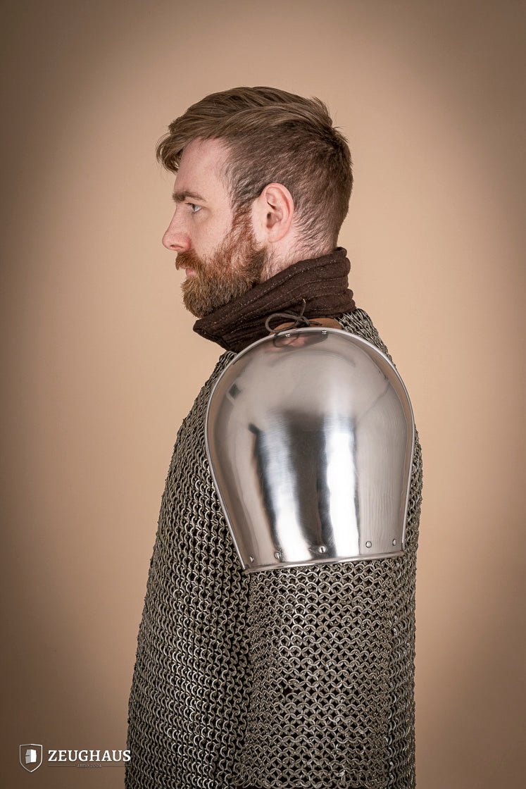 Polished steel pauldrons from 1350-1425, showcasing intricate craftsmanship and historical design.