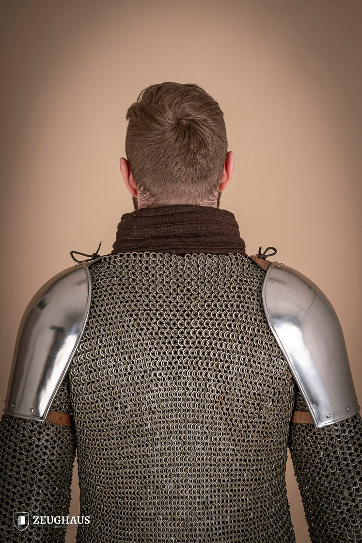 Polished steel pauldrons from 1350-1425, showcasing intricate craftsmanship and historical design.