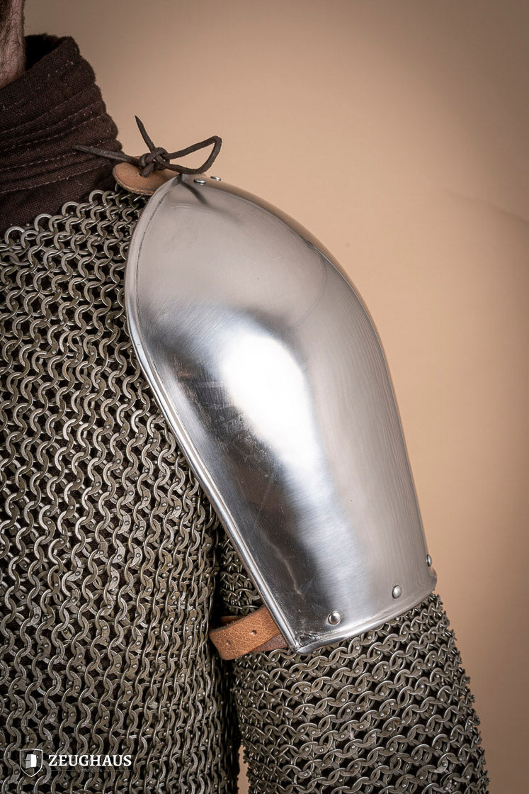 Polished steel pauldrons from 1350-1425, showcasing intricate craftsmanship and historical design.