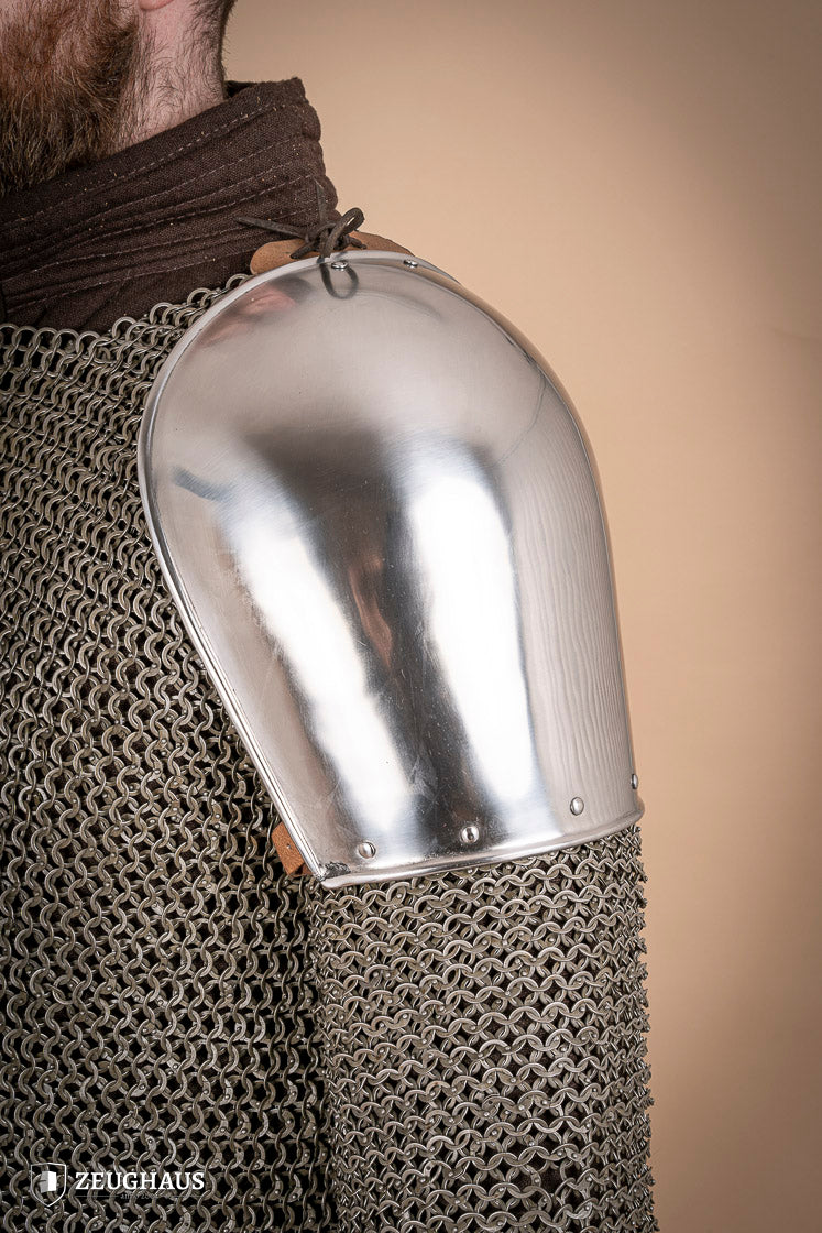 Polished steel pauldrons from 1350-1425, showcasing intricate craftsmanship and historical design.