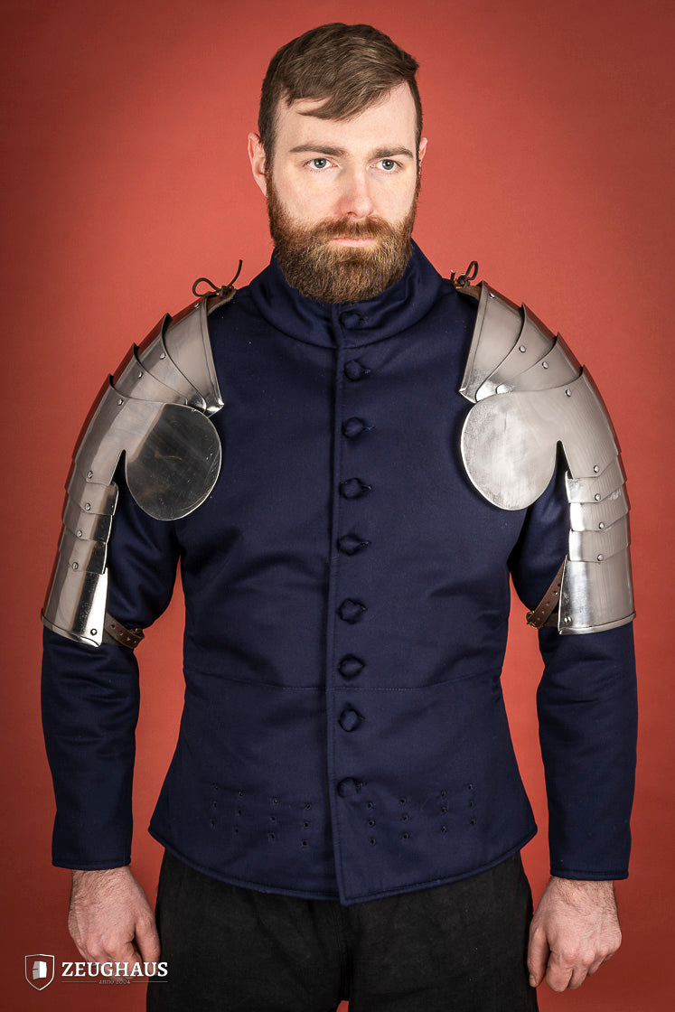 Polished steel pauldrons from 1400-1450, featuring a besagew for added stability and protection, showcasing a historical design.