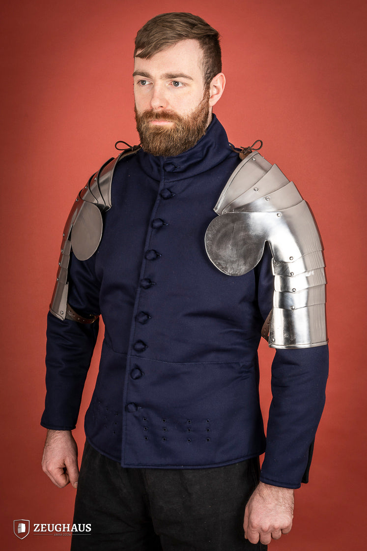 Polished steel pauldrons from 1400-1450, featuring a besagew for added stability and protection, showcasing a historical design.