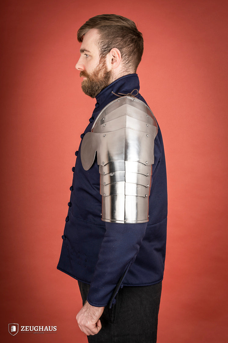 Polished steel pauldrons from 1400-1450, featuring a besagew for added stability and protection, showcasing a historical design.