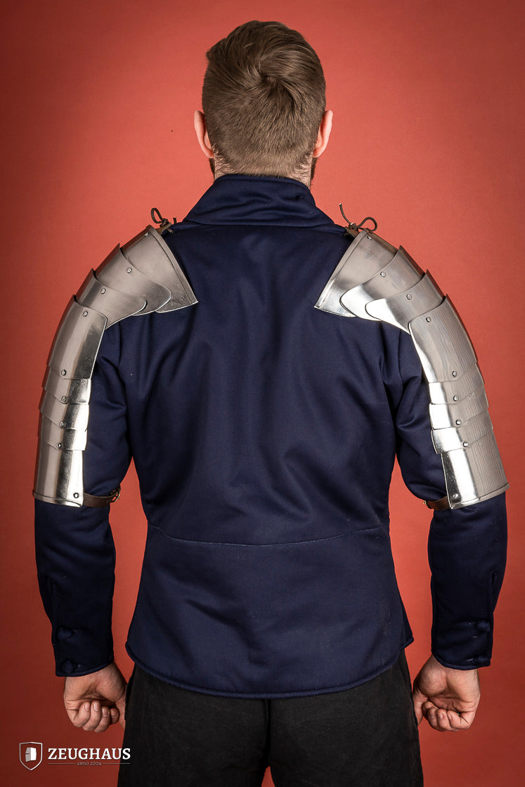 Polished steel pauldrons from 1400-1450, featuring a besagew for added stability and protection, showcasing a historical design.