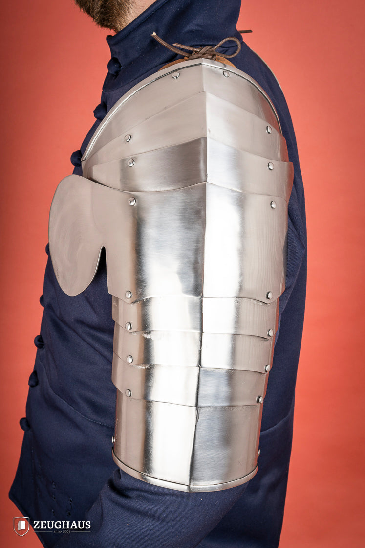Polished steel pauldrons from 1400-1450, featuring a besagew for added stability and protection, showcasing a historical design.