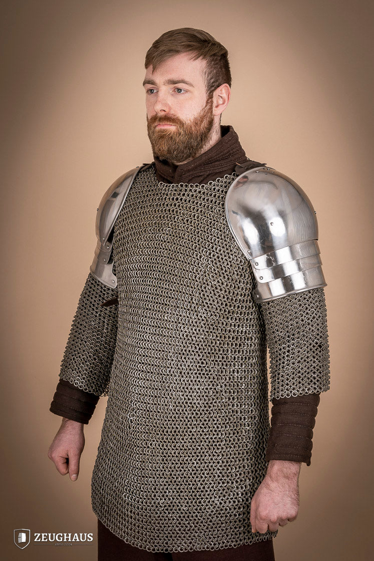 Polished 1460 pauldrons made of 1.6mm steel, showcasing a satin finish and handcrafted details for medieval armor enthusiasts.