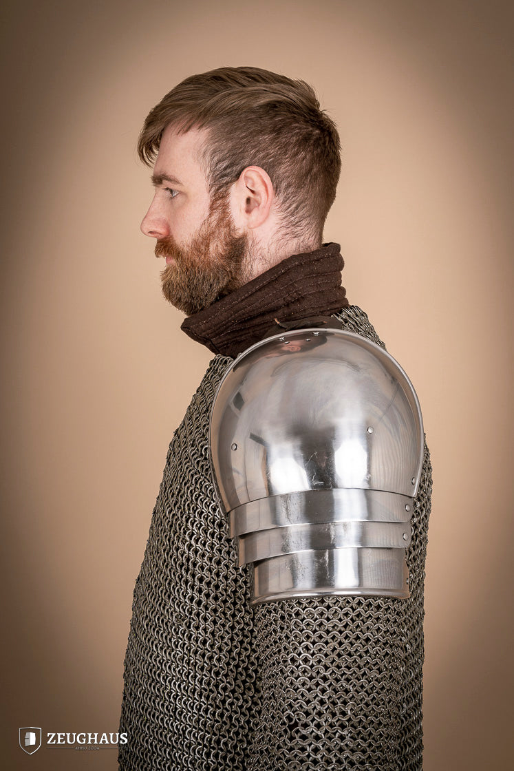 Polished 1460 pauldrons made of 1.6mm steel, showcasing a satin finish and handcrafted details for medieval armor enthusiasts.
