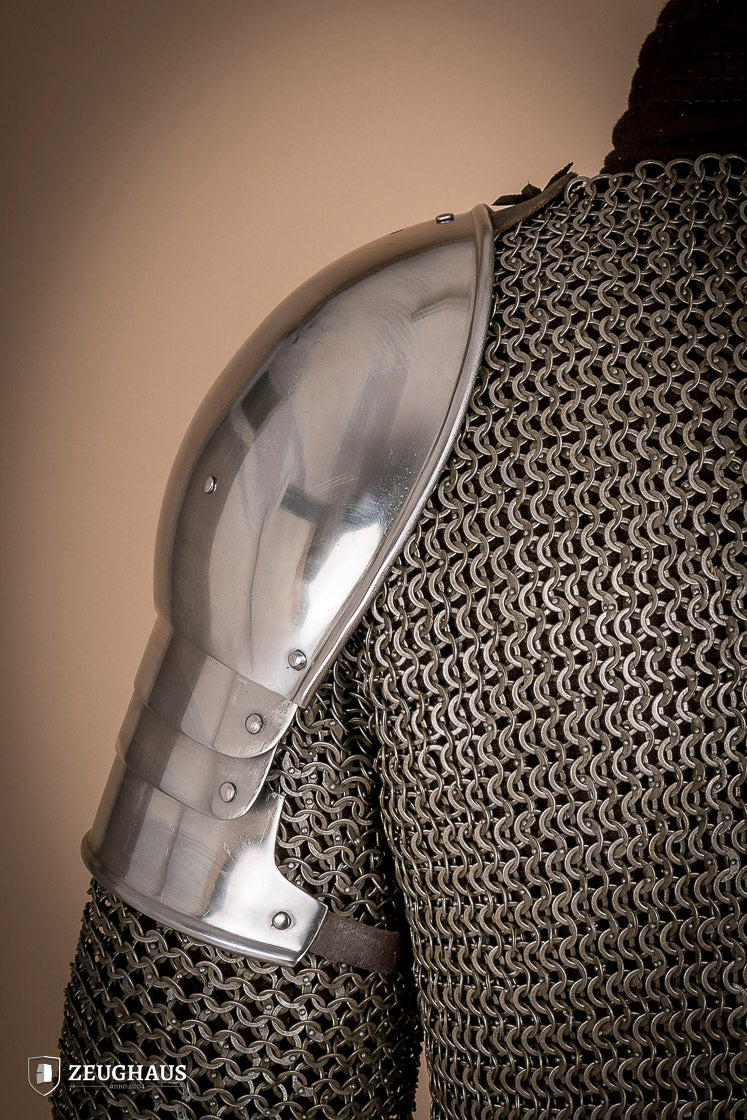 Polished 1460 pauldrons made of 1.6mm steel, showcasing a satin finish and handcrafted details for medieval armor enthusiasts.