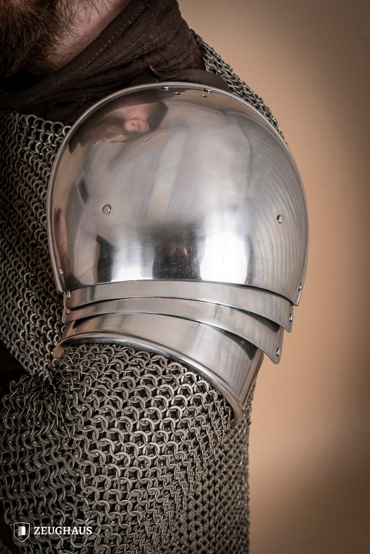 Polished 1460 pauldrons made of 1.6mm steel, showcasing a satin finish and handcrafted details for medieval armor enthusiasts.