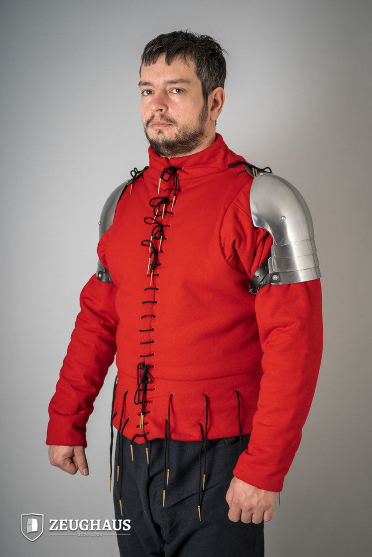 Polished 14th Century pauldrons made of 1.6mm steel, showcasing intricate design and sturdy leather cords for attachment.